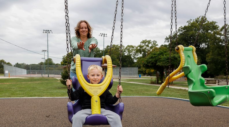 Kayla Elliott pushes her 4-year-old son Grayson Elliott on a swing on Snyder Park playground on Thursday, August 28, 2025, in Springfield. JOSEPH COOKE/STAFF