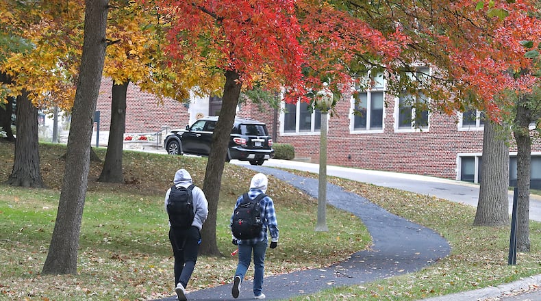 Two Wittenberg University students walk across campus. BILL LACKEY/STAFF