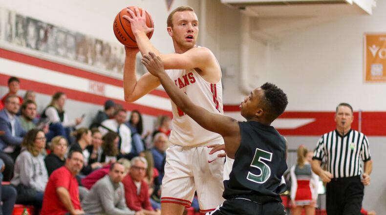 Southeastern High School senior Bryce Grim is guarded by Catholic Central sophomore Camron Roe during their game on Dec. 17, 2019. The Trojans started the season 1-7, but have won three of their last four games, including an upset of OHC North Division leader Fairbanks. CONTRIBUTED PHOTO BY MICHAEL COOPER