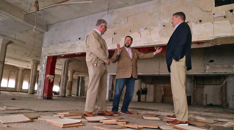 Ted Vander Roest, former executive director of the Springfield Foundation, talks with John Landess and Daren Cotter, from the Turner Foundation, about the apartments that will be located in the upper floors of the Wren Building in downtown Springfield in this file photo. BILL LACKEY/STAFF
