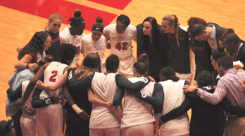 The Dayton women’s basketball team huddles before a game in 2018 at UD Arena. David Jablonski/Staff