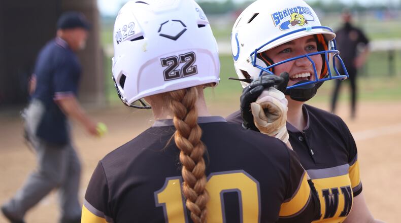 Shawnee High School senior Tori Huxley celebrates with junior Dani Ross after hitting a home run against Tippecanoe in a D-II district semifinal game on Tuesday at Northwestern High School. The Braves won 5-4 in 10 innings. CONTRIBUTED PHOTO BY MICHAEL COOPER
