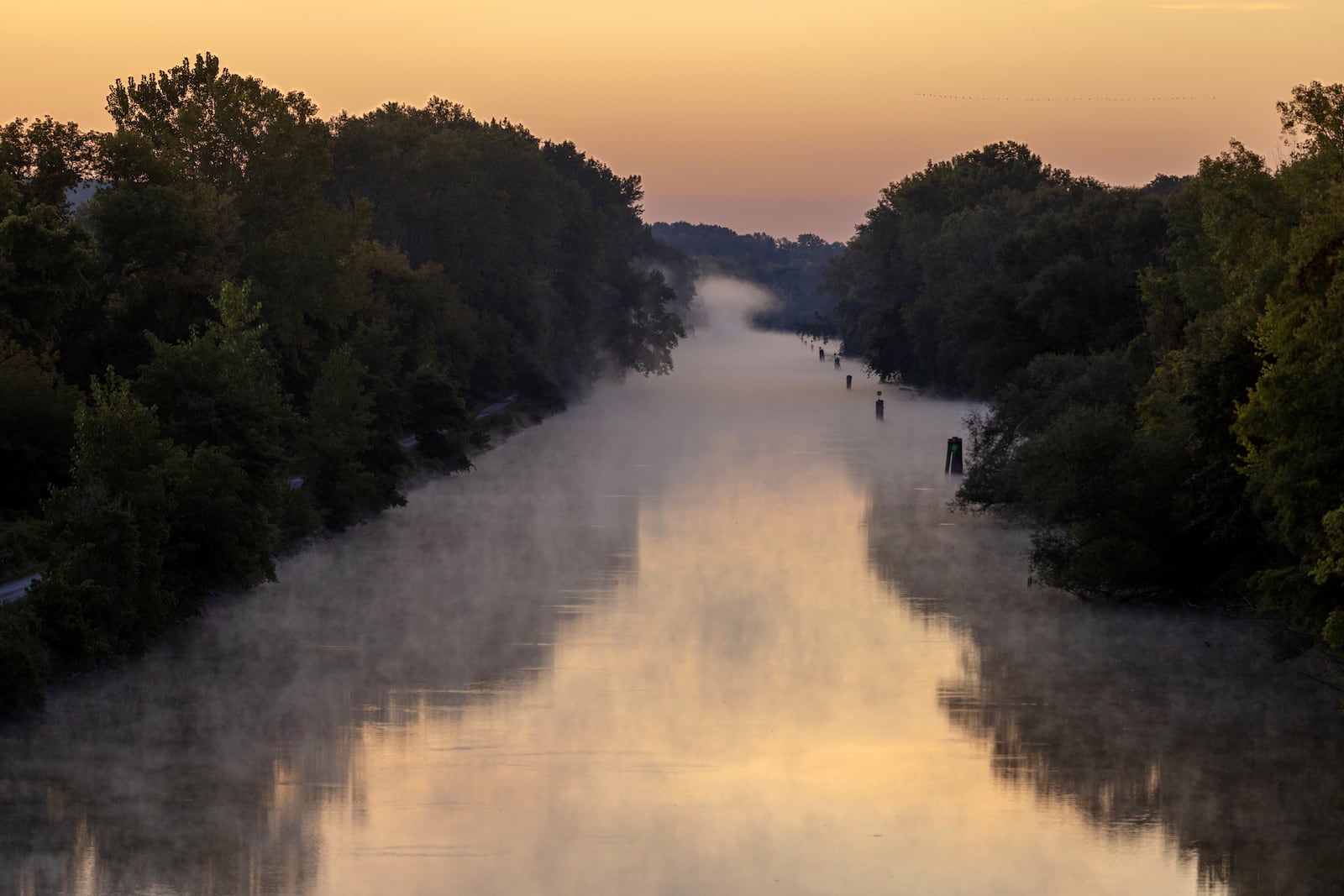 Sunrise on the Erie Canal in Fairport, N.Y., Sept. 21, 2025. As the 200th anniversary of the Erie Canal approaches on Oct. 26, organizers are seeking to temper the celebration with an acknowledgment of the waterway’s displacement of Native American communities. (Lauren Petracca/The New York Times)