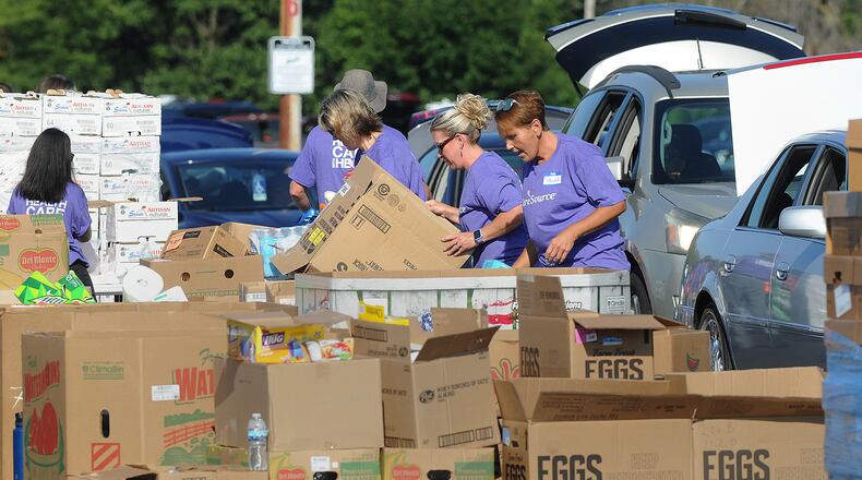 The Dayton Foodbank, Inc. along with nearly 200 volunteers from CareSource served over 1,000 families at the University of Dayton Arena Mass food distribution Tuesday Aug. 23, 2022. MARSHALL GORBY\STAFF