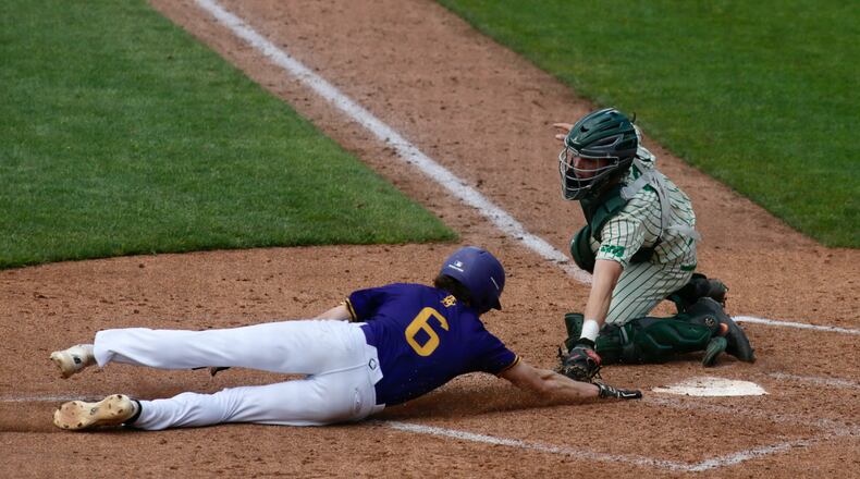 Badin catcher Jimmy Nugent tags out Bloom-Carroll's Evan Dozer at home plate in a Division II state semifinal on Friday, June 11, 2021, at Canal Park in Akron. David Jablonski/Staff