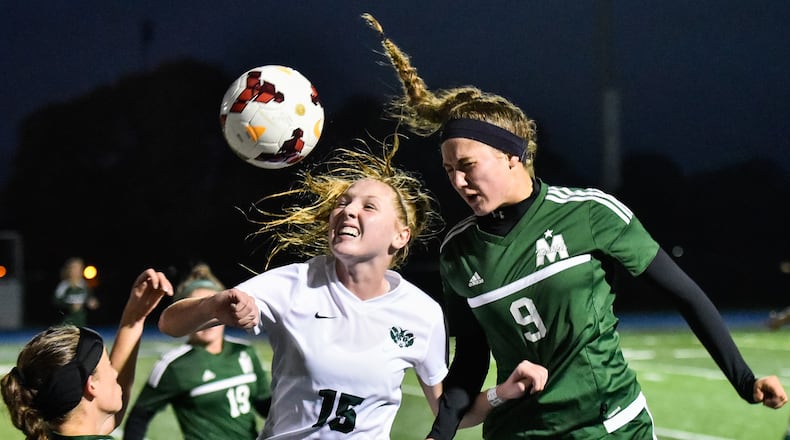 Badin’s Gabby Riesing (15) and McNicholas’ Mackenzie Burdick (9) battle for the ball during their Division II sectional final soccer game Monday, Oct. 23 at Winton Woods High School. Badin advances with a 2-1 win. NICK GRAHAM/STAFF