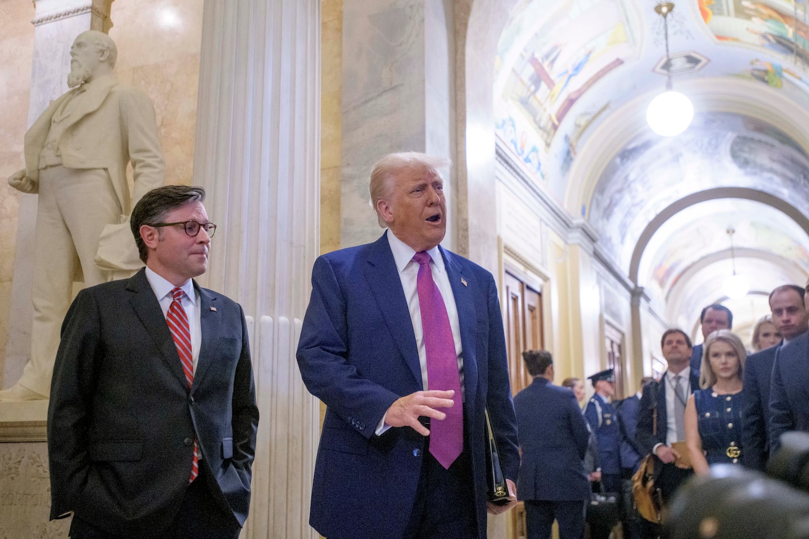 President Donald Trump, right, is joined by Speaker of the House Mike Johnson, R-La., as he arrives for a meeting with the House Republican Conference at the Capitol, Tuesday, May 20, 2025, in Washington. (AP Photo/Rod Lamkey, Jr.)