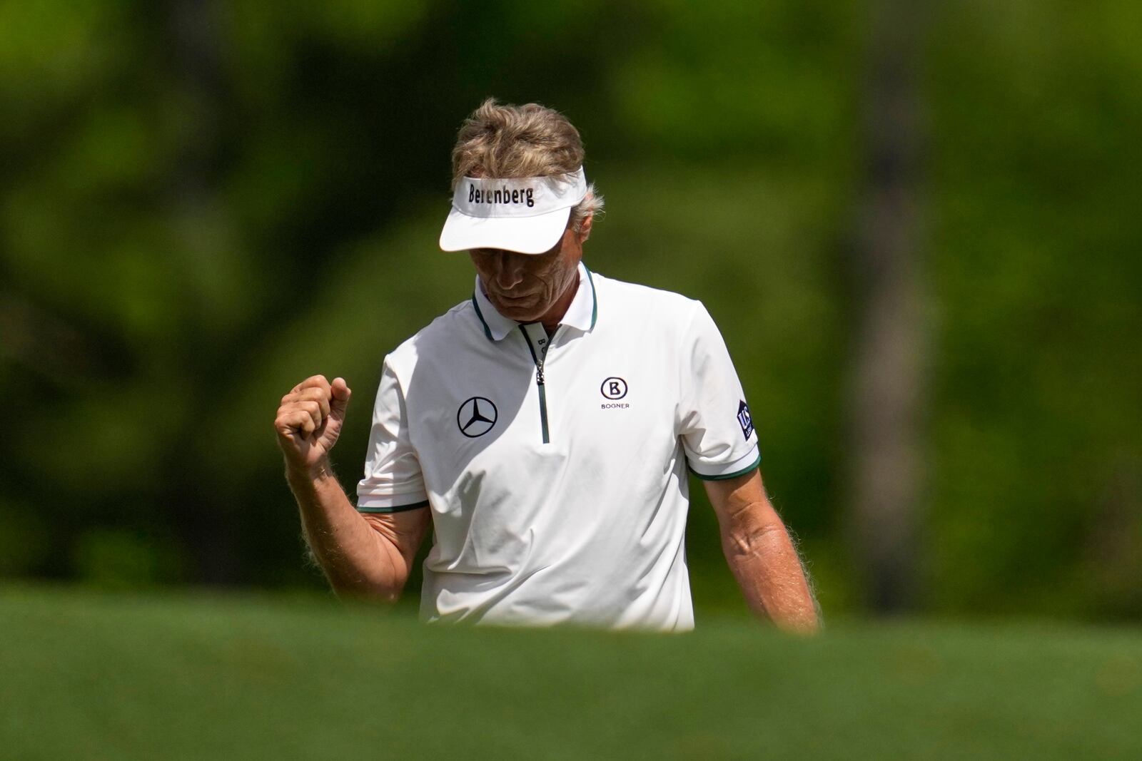 Bernhard Langer, of Germany, celebrates after his shot on the 12th hole during the second round at the Masters golf tournament, Friday, April 11, 2025, in Augusta, Ga. (AP Photo/Ashley Landis)