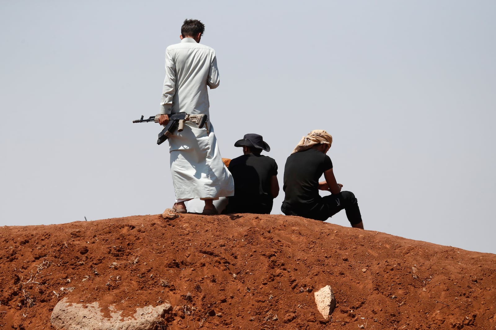 Bedouin fighters gather as Syrian government security forces block them from entering Sweida province, in Busra al-Harir village, southern Syria, Sunday, July 20, 2025. (AP Photo/Omar Sanadiki)