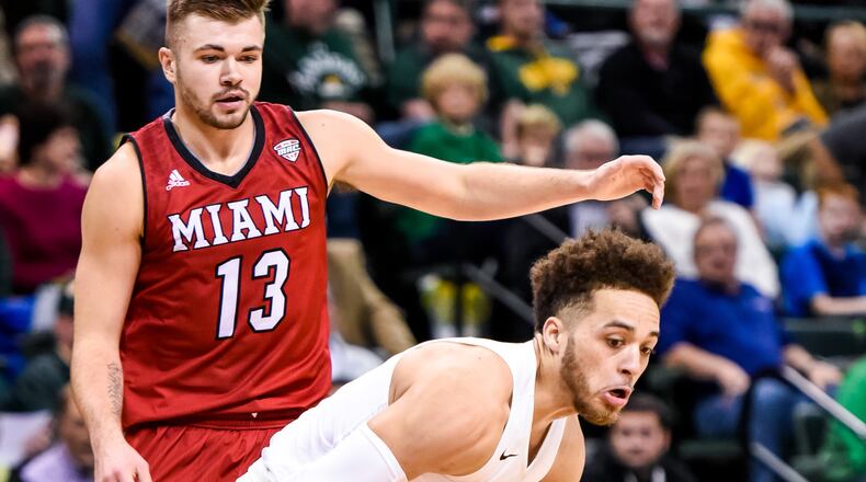 Wright State University’s Justin Mitchell dribbles to the basket with Miami University’s Jake Wright behind him during their 89-87 win over Miami Tuesday, Nov. 15, 2016, at Wright State University’s Nutter Center in Fairborn. Mitchell is NICK GRAHAM/STAFF