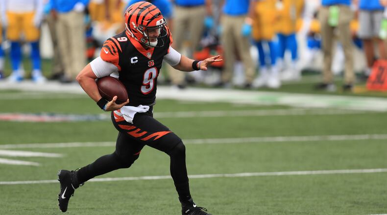 Cincinnati Bengals quarterback Joe Burrow (9) runs for a touchdown during the first half of an NFL football game against the Los Angeles Chargers, Sunday, Sept. 13, 2020, in Cincinnati. (AP Photo/Aaron Doster)