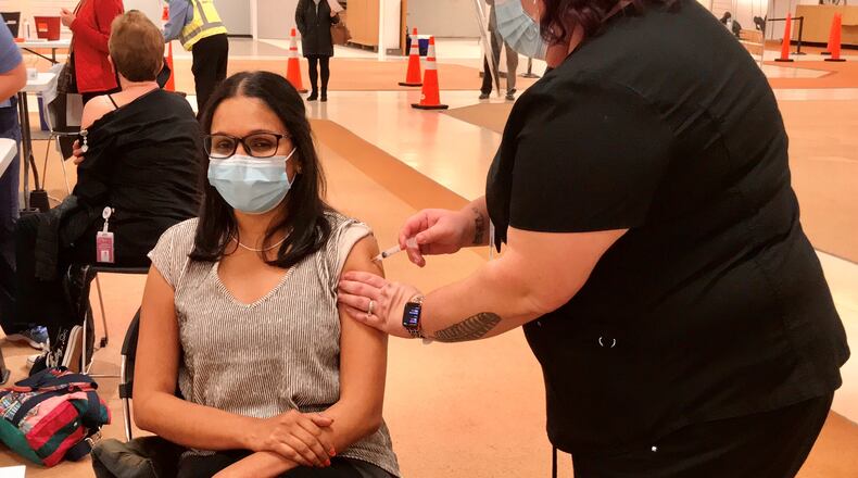 Rocking Horse Community Health Center's Chief Medical Director Dr. Yamini Teegala was the health center's first to receive the COVID-19 vaccine on Tuesday. Teegala said of the roughly 220 Rocking Horse employees eligible to receive the vaccine right now, only about 40 to 50% want it. Riley Newton/Staff
