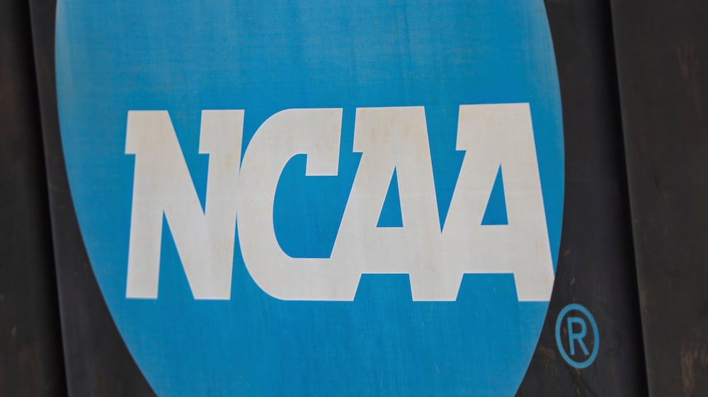 FILE - An NCAA logo displayed on the fence before an NCAA softball game between Jacksonville and FGCU, March 24, 2024, in Jacksonville, Fla. (AP Photo/Gary McCullough, File)