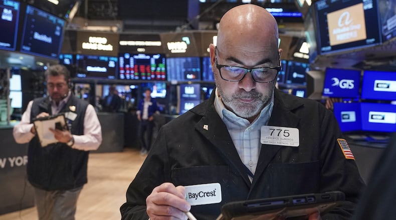 Trader Fred Demarco, right, works on the floor of the New York Stock Exchange, Friday, Feb. 13, 2026, in New York. (AP Photo/Richard Drew)