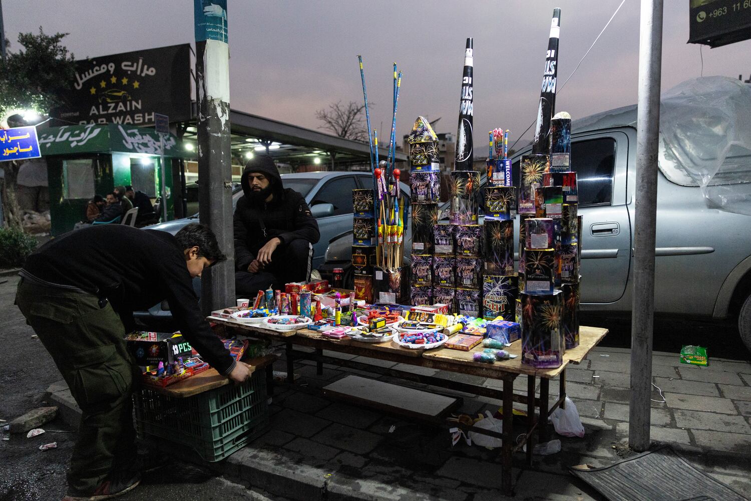 Vendors sell fireworks on the sidewalk on New Year’s Eve in Damascus, Syria, on Tuesday, Dec. 31, 2024. (David Guttenfelder/The New York Times)