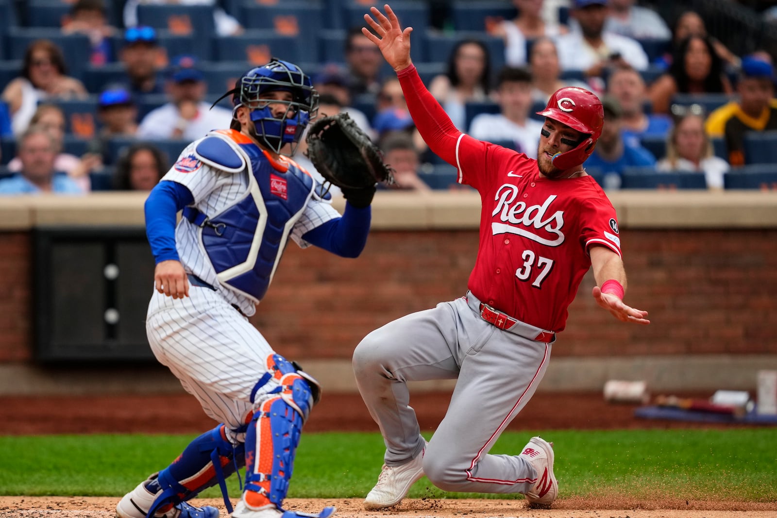 Cincinnati Reds' Tyler Stephenson (37) slides into home base during the sixth inning of a baseball game against the New York Mets, Saturday, July 19, 2025, in New York. (AP Photo/Yuki Iwamura)