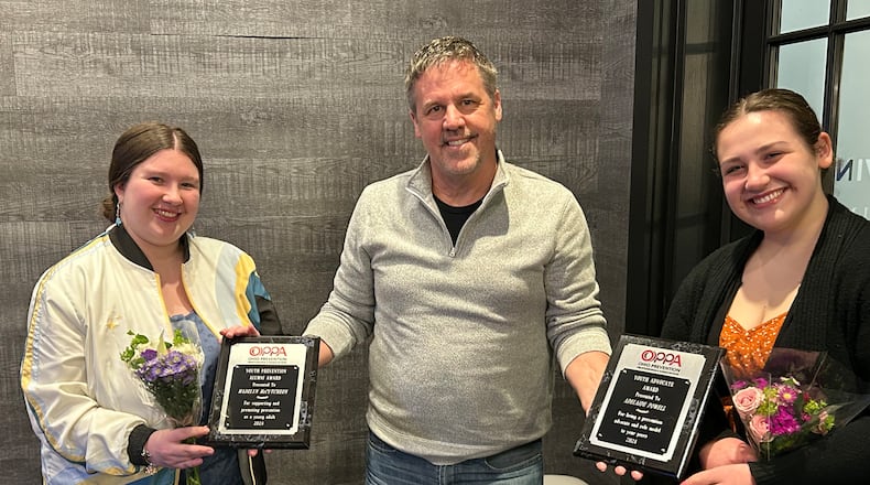 Ohio Prevention Professionals Association executive director Jim Ryan presents state awards to Madelyn McCutcheon, left, and Adelaide Powell for their efforts in promoting prevention and healthy lifestyles to their peers in Springfield's youth community.