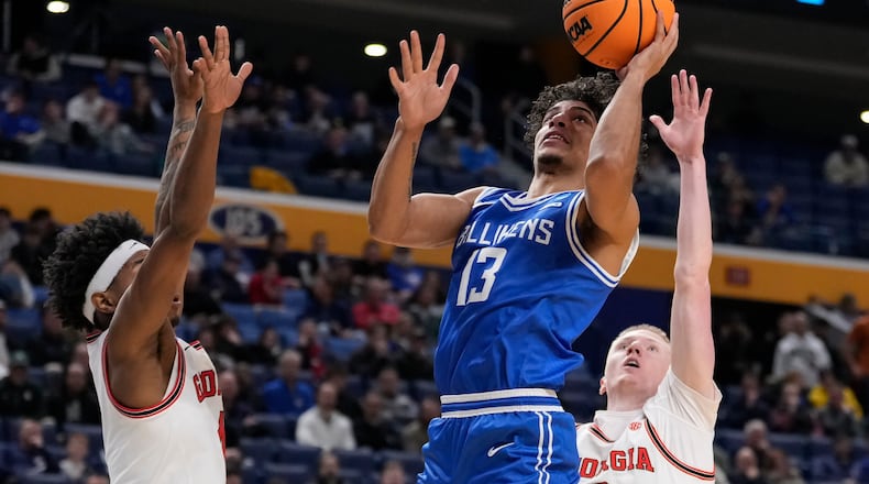 Saint Louis guard Dion Brown (13) shoots over Georgia guard Blue Cain (0) during the second half in the first round of the NCAA college basketball tournament, Thursday, March 19, 2026, in Buffalo, N.Y. (AP Photo/Yuki Iwamura)