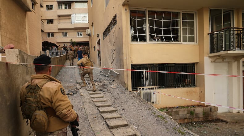 Lebanese army soldiers check the site where intercepted missiles fell in Sahel Alma, north of Beirut, Lebanon, Tuesday, March 24, 2026. (AP Photo/Hassan Ammar)