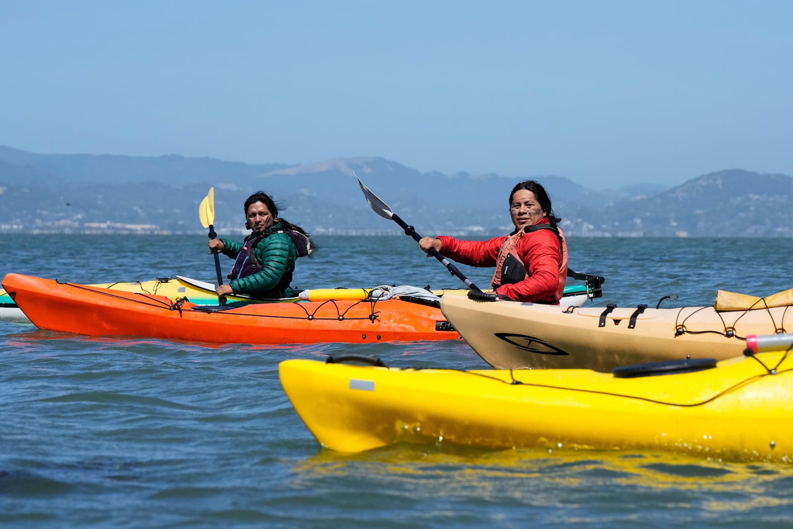 From left, Juan Bay, president of the Waorani people of Ecuador, and Nadino Calapucha, a spokesperson for the Kichwa Pakkiru people, kayak in the San Francisco Bay, Thursday, June 19, 2025, in Richmond, Calif. (AP Photo/Godofredo A. Vásquez)