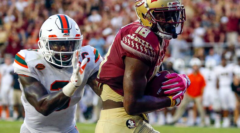 TALLAHASSEE OCTOBER 7: Wide receiver Auden Tate #18 of the Florida State Seminoles catches a pass for a touchdown over defensive back Dee Delaney #3 of the Miami Hurricanes during the second half of an NCAA football game at Doak S. Campbell Stadium on October 7, 2017 in Tallahassee, Florida. (Photo by Butch Dill/Getty Images)