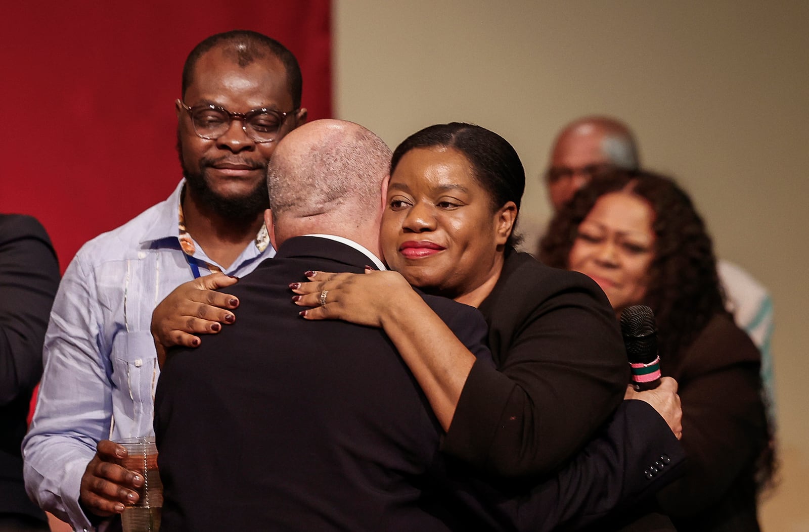 Pastor Jose Salas, of Iglesia Hispana Emanuel, left, hugs Geurline Jozef, founder of the Haitian Bridge Alliance, during Here We Stand: Faith Leaders for Immigration Justice & Family Unity at St. John Missionary Baptist Church on Monday, Feb. 2, 2026, in Springfield. Pastors, faith leaders and community members gathered to pray and call for the extension of Temporary Protected Status which is scheduled to expire on Tuesday, Feb. 3, 2026. JOSEPH COOKE/STAFF