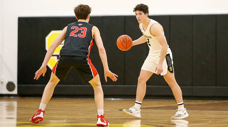 Cutline: Shawnee High School senior Patrick Fultz is guarded by Tecumseh's Collin O'Connor during their game earlier this season in Springfield. Fultz recently set school records for career assists and steals. Michael Cooper/CONTRIBUTED