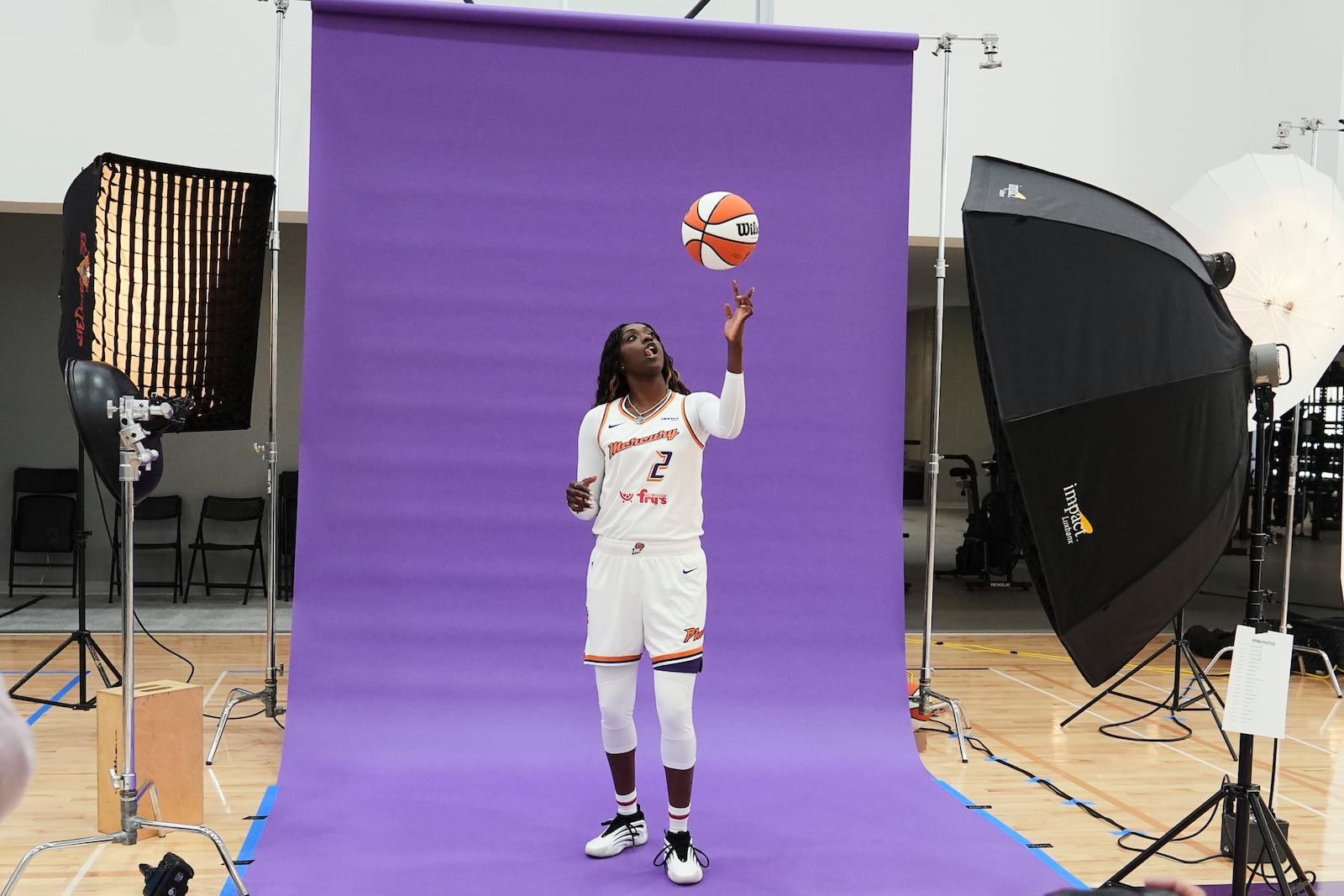 Phoenix Mercury guard-forward Kahleah Copper flips the ball in the air during a photo shoot at Mercury Media Day at the team's WNBA basketball training facility, Wednesday, April 30, 2025, in Phoenix. (AP Photo/Ross D. Franklin)