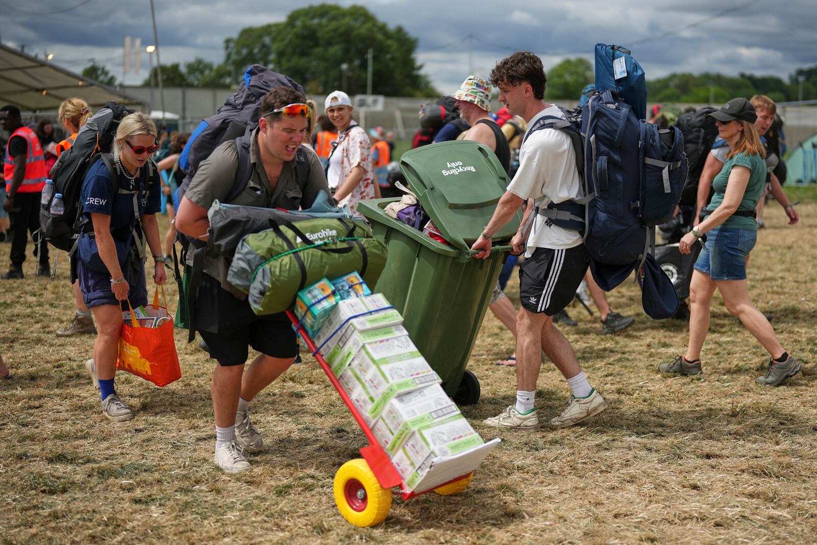 Festival goers arrive at the Glastonbury Festival in Worthy Farm, Somerset, England, Wednesday, June 25, 2025. (Scott A Garfitt/Invision/AP)
