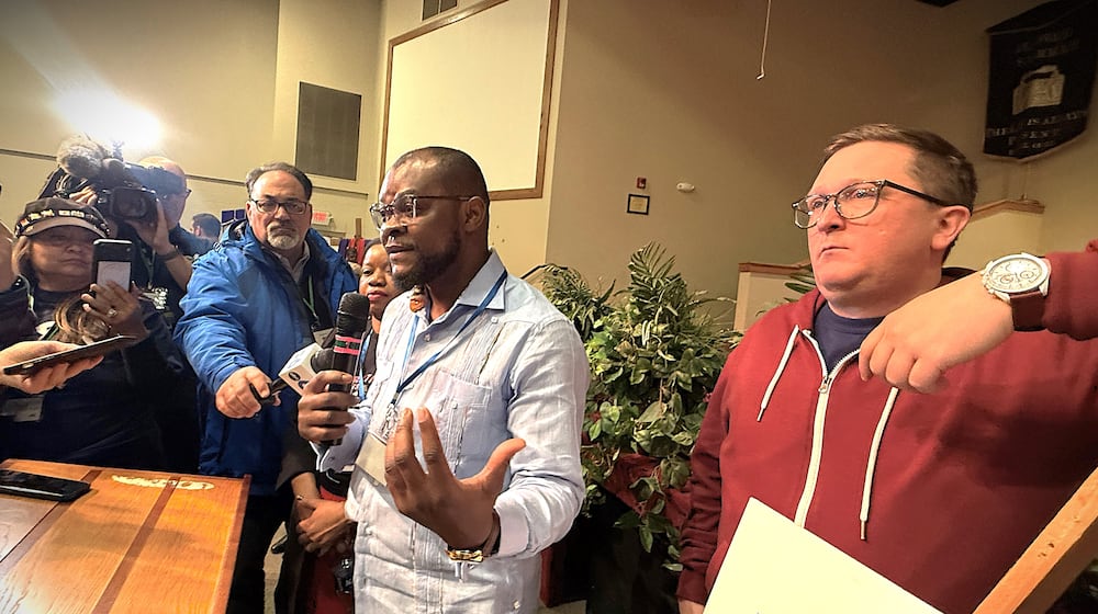 Viles Dorsainvil, the co-founder and executive director of the Haitian Community Help & Support Center in Springfield, spoke at a community event in Springfield on Monday, Feb. 2, 2026, in support of extending temporary protected status for Haiti. Dorsainvil and his brother are plaintiffs in lawsuits challenging the Trump administration's cancellation of TPS for Haitians. He stood next to Geoff Pipoly, lead counsel in a federal court case in Washington, DC. CORNELIUS FROLIK / STAFF