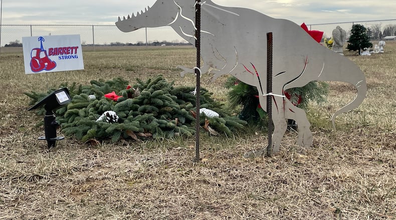 A T-rex cut-out marks the grave of nine-year-old Barrett Fitzsimmons in Myers Cemetery.