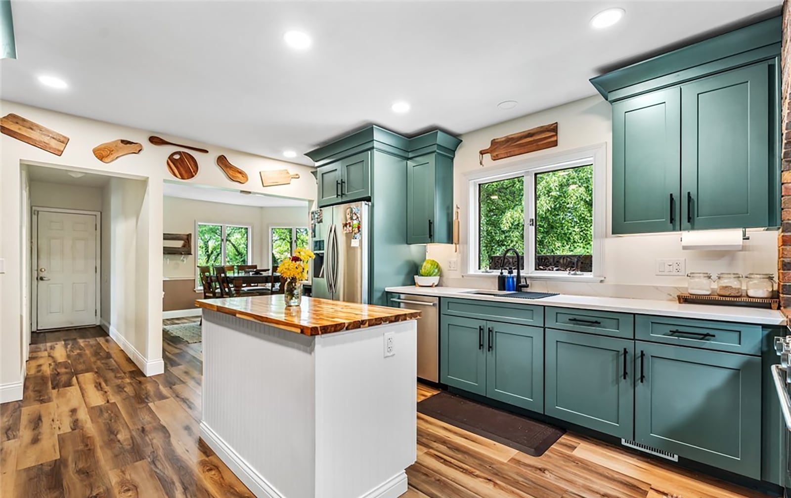 The newly remodeled kitchen features custom cabinets, an island, LVT flooring and professional stainless steel appliances. CONTRIBUTED