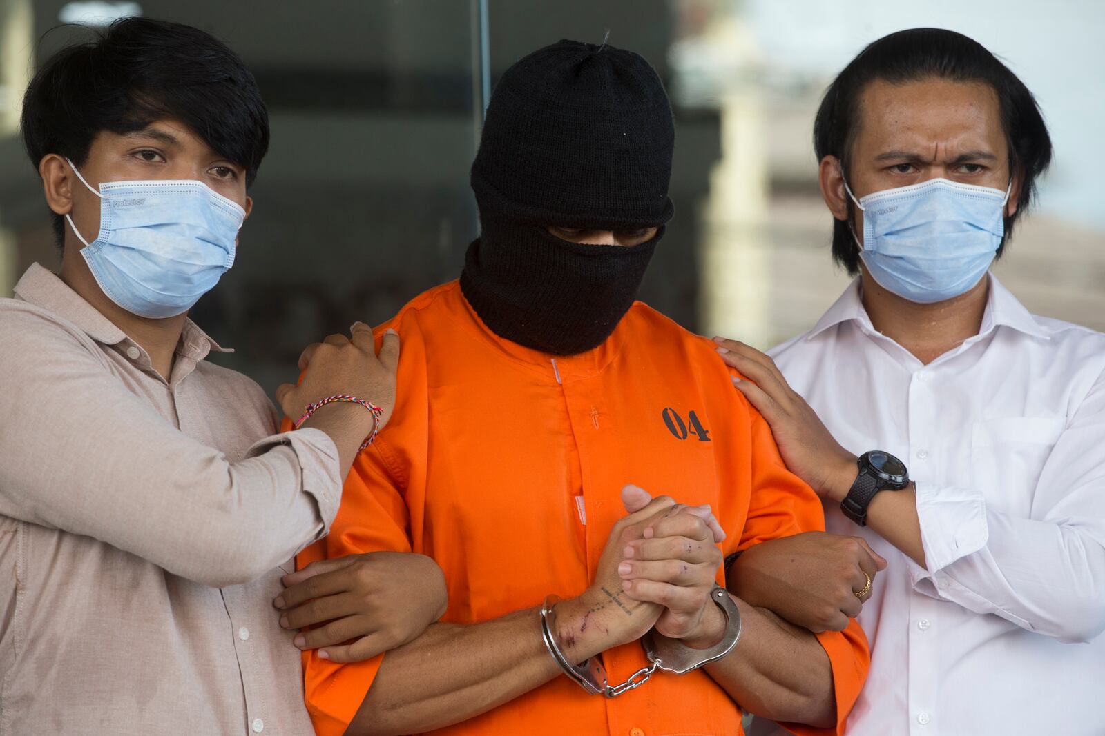 An Australian man arrested for allegedly smuggling cocaine stands escorted during a news conference at the police headquarters in Bali, Indonesia, Monday, May 26, 2025. (AP Photo/Firdia Lisnawati)