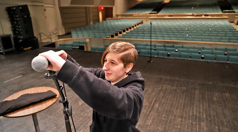 Marissa Lee sets up the microphones on stage at Kuss Auditorium on Thursday, March 16, 2023, as she and other stage personnel get ready for a show by Sheena Easton later that evening at the Clark State Performing Arts Center in Springfield. BILL LACKEY/STAFF