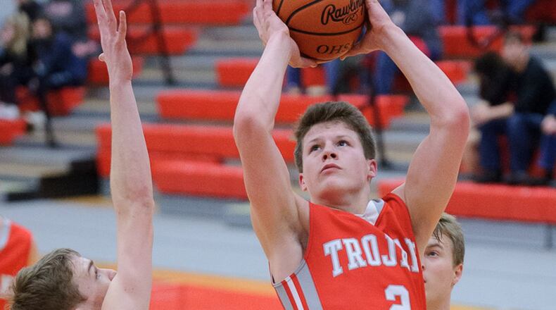 Southeastern junior Tyler King shoots with pressure from Newton’s Austin Evans during a Division IV sectional semifinal Wednesday at the Trojan Activities Center. BRYANT BILLING / CONTRIBUTED