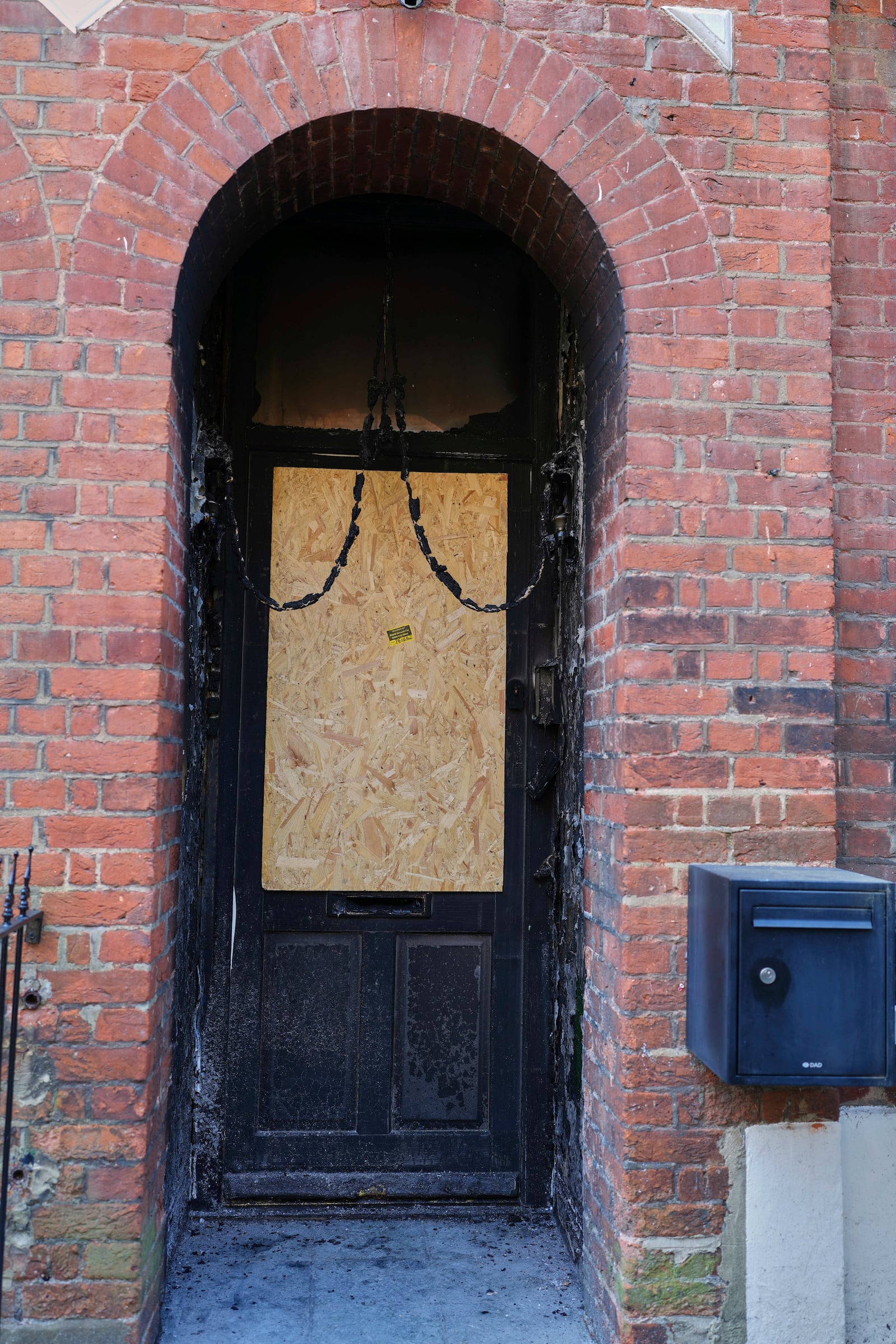 Fire damage is seen in the doorway of a house belonging to British Prime Minister Keir Starmer in Kentish Town in London, Tuesday, May 13, 2025. (AP Photo/Kirsty Wigglesworth)