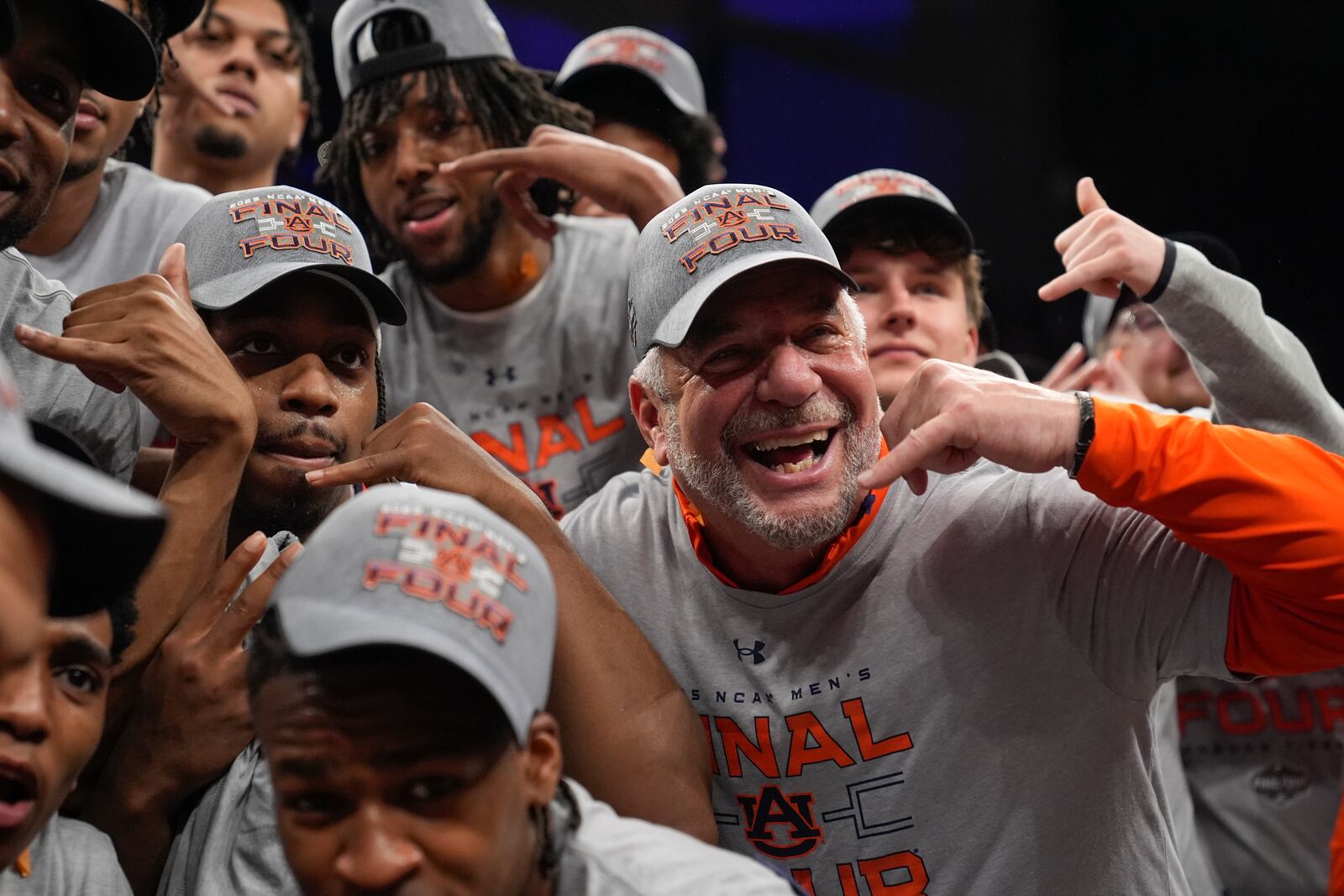 Auburn head coach Bruce Pearl celebrates with the team after the Elite Eight of the NCAA college basketball tournament against Michigan State, Sunday, March 30, 2025, in Atlanta. (AP Photo/Brynn Anderson)