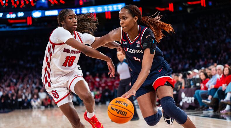 UConn guard Blanca Quinonez (4), guarded by St. John's guard Brooke Moore (10), heads toward the basket during the first half of an NCAA college basketball game, Sunday, March 1, 2026, in New York. (AP Photo/Angelina Katsanis)