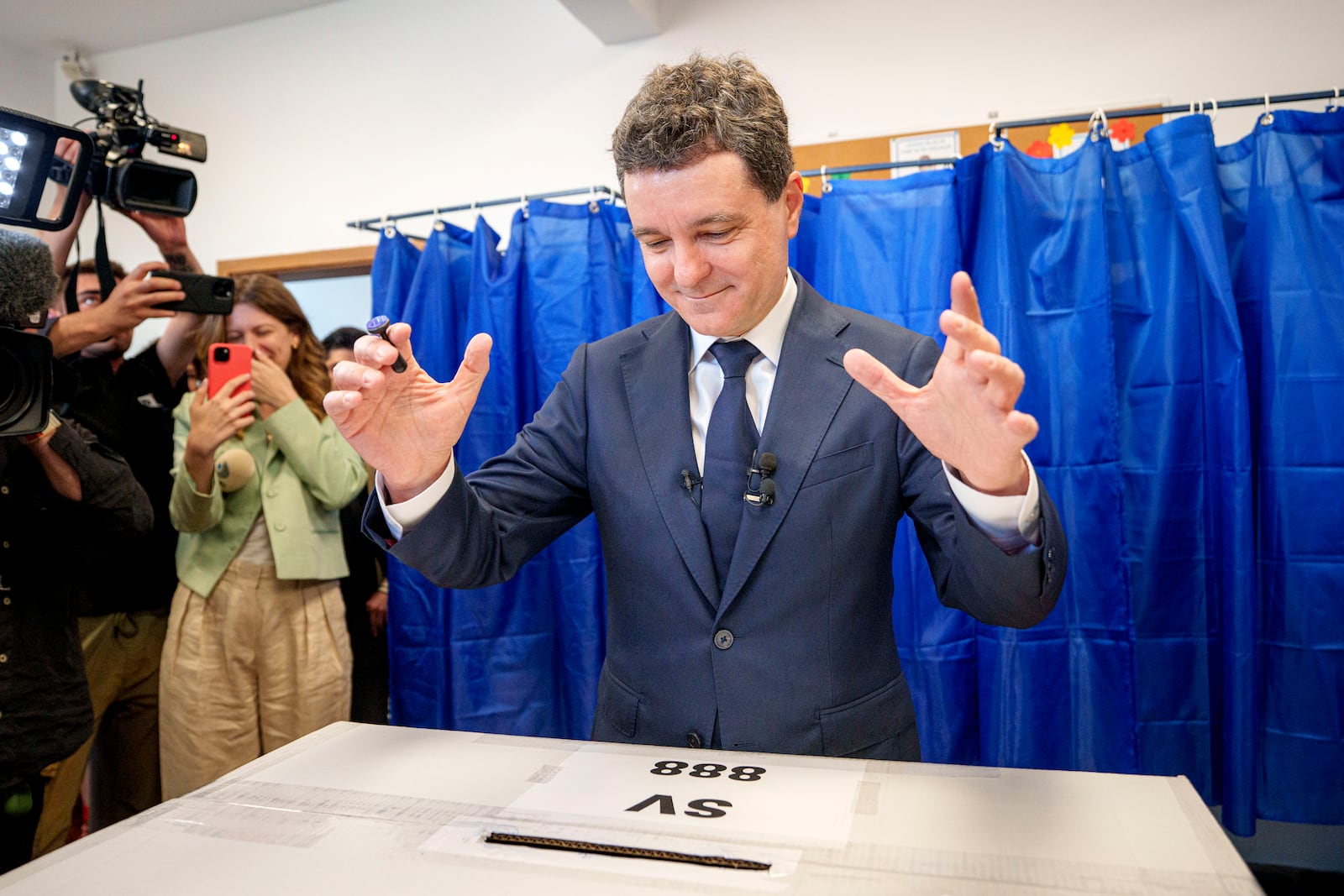 Presidential candidate Nicusor Dan reacts after casting his vote in the first round of the presidential election redo in Bucharest, Romania, Sunday, May 4, 2025. (AP Photo/Andreea Alexandru)