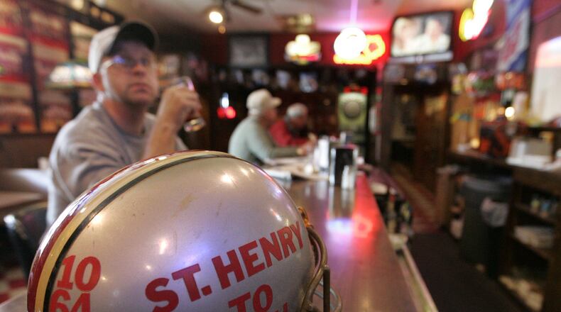 31 Oct 07 Photo by Ron Alvey. A football helmet, on the bar at Fish-Mo’s, is adorned with numbers of St. Henry High School football players that went on to play for The Ohio State Buckeyes. Fish-Mo’s is a sports bar in St. Henry Ohio. Todd Boeckman’s, the Buckeye quarterback and a graduate of St. Henry, wears the number 17.