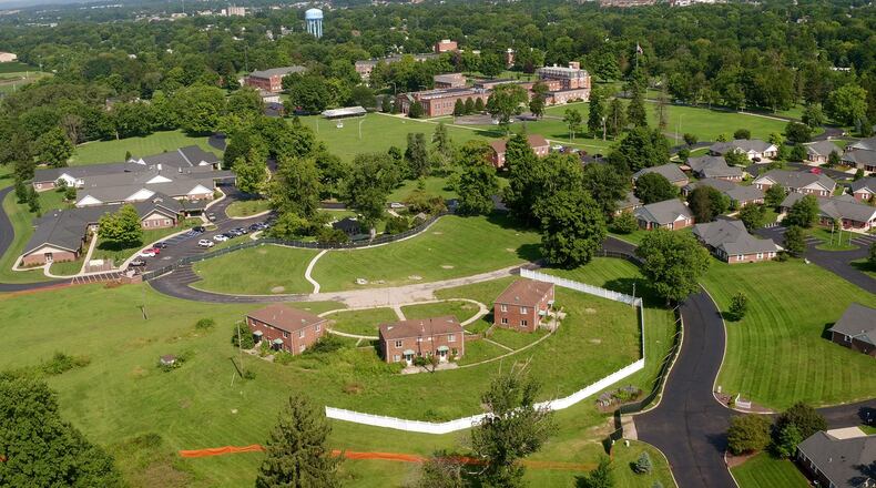 Legacy Village in Xenia announced plans to expand by building market-rate luxury apartments for seniors next to existing homes. The area to be developed is show at the bottom of this photo surrounded by fence. TY GREENLEES / STAFF
