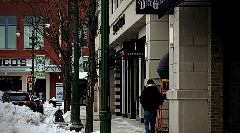 Patrons brave the cold and snow at the Greene Town Center in Beavercreek, Friday, Jan. 10, 2025. LONDON BISHOP/STAFF