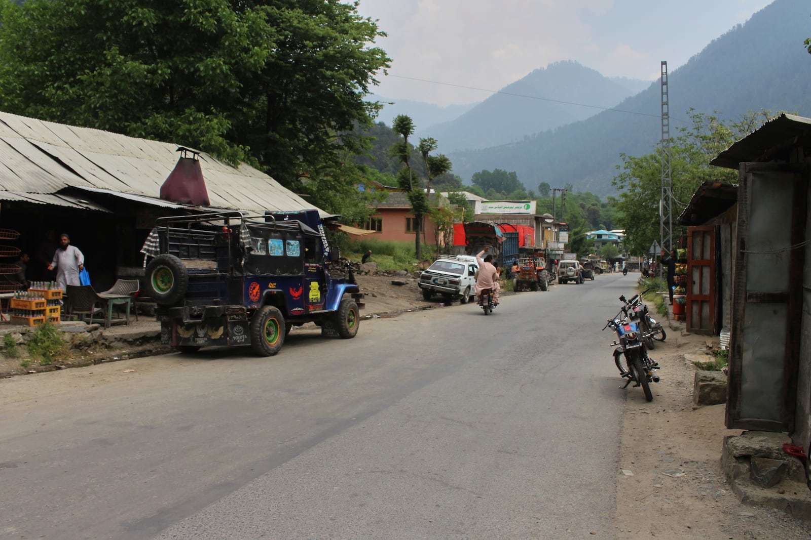 A motorcyclist drives through an empty market at a tourists point in Karen, in the Neelum Valley near on the Line of Control, the de facto border that divides the disputed region of Kashmir, some 93 kilometres (58 miles) from Muzaffarabad, the capital of Pakistan controlled Kashmir, Thursday, May 1, 2025. (AP Photo/Ishfaq Hussain)