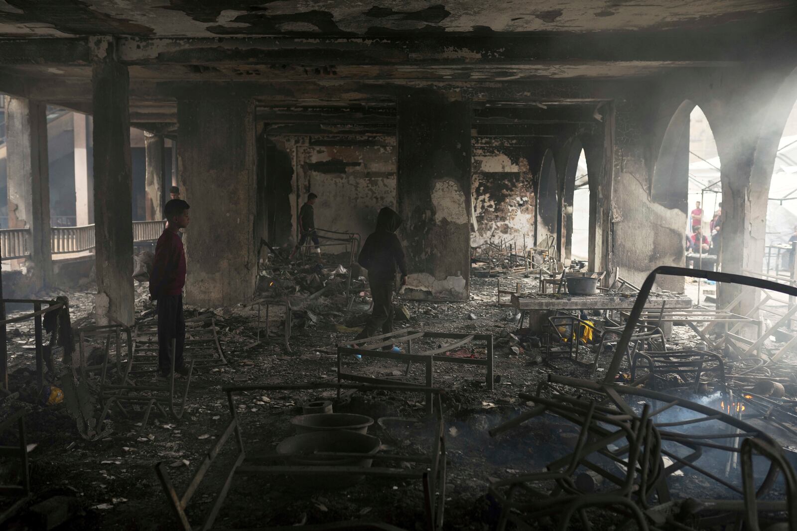 Palestinians inspect the damage after an Israeli army airstrike on Yaffa School, in Gaza City, Wednesday, April 23, 2025. (AP Photo/Jehad Alshrafi)