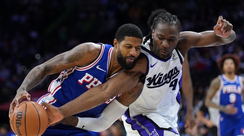Philadelphia 76ers' Paul George, left, tries to get past Sacramento Kings' Precious Achiuwa during the second half of an NBA basketball game Thursday, Jan. 29, 2026, in Philadelphia. (AP Photo/Matt Slocum)