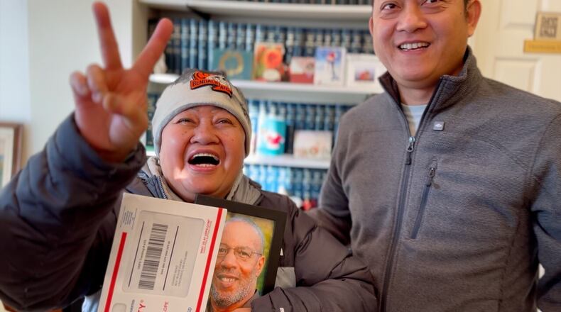 Channy Heng and her son react after receiving their green cards. Heng's family has been fighting immigration services for more than a decade. KEITH BIERYGOLICK/WCPO
