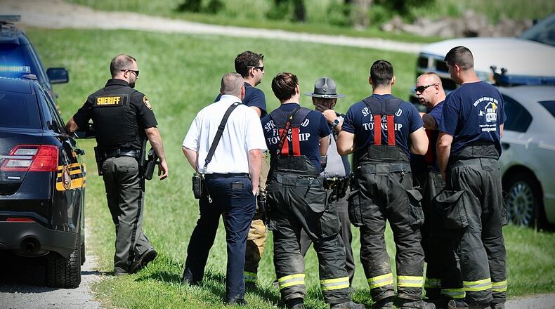 Emergency personnel on standby on E. Possum Rd. For a helicopter crash in a cornfield near I 70 Saturday, July 29, 2023. MARSHALL GORBY \STAFF