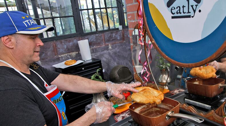 Tom Thompson, owner of Eatly, deep fries a pizza dough Thursday, May 23, 2024. BILL LACKEY/STAFF