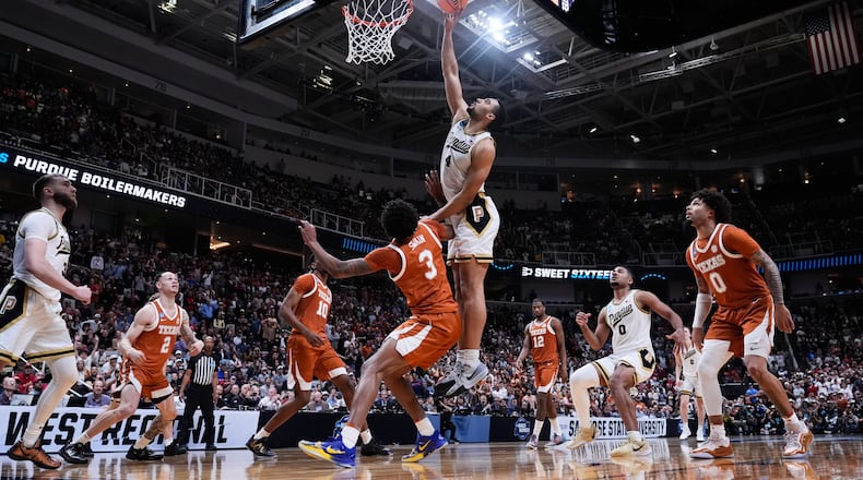 Purdue forward Trey Kaufman-Renn (4) tips the ball over Texas forward Dailyn Swain (3) for the game-winning basket during the second half in the Sweet 16 of the NCAA college basketball tournament, Thursday, March 26, 2026, in San Jose, Calif. (AP Photo/Godofredo A. Vásquez)
