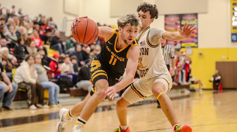 Shawnee High School senior Holton Massie drives past Kenton Ridge's Xavier White during their game on Monday night at Kenton Ridge High School. The Braves won 38-33. CONTRIBUTED PHOTO BY MICHAEL COOPER